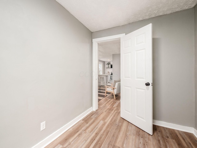 interior space with a textured ceiling and light wood-type flooring