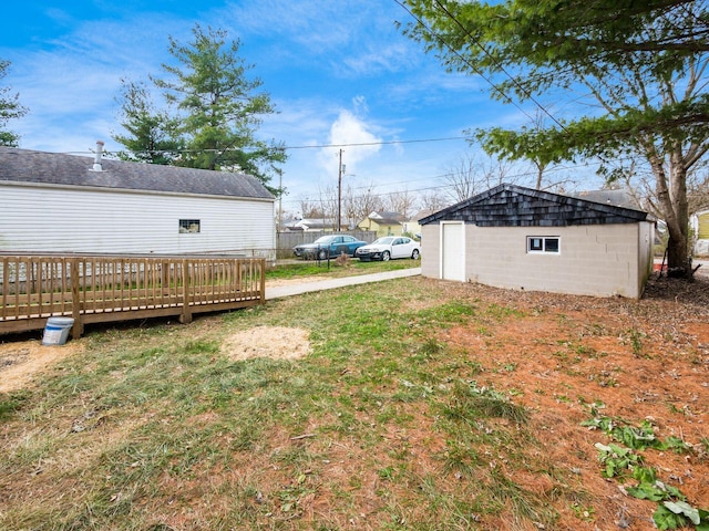 view of yard with an outbuilding and a wooden deck