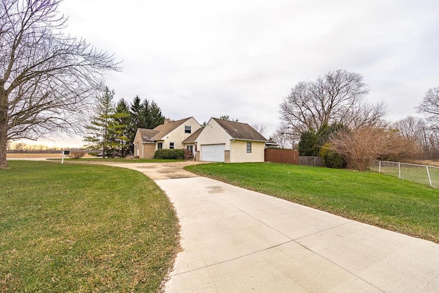 view of front of property with a garage and a front lawn