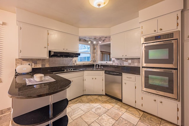 kitchen featuring appliances with stainless steel finishes, white cabinetry, and sink