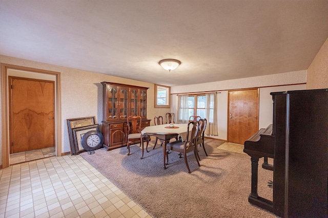 dining area featuring light colored carpet