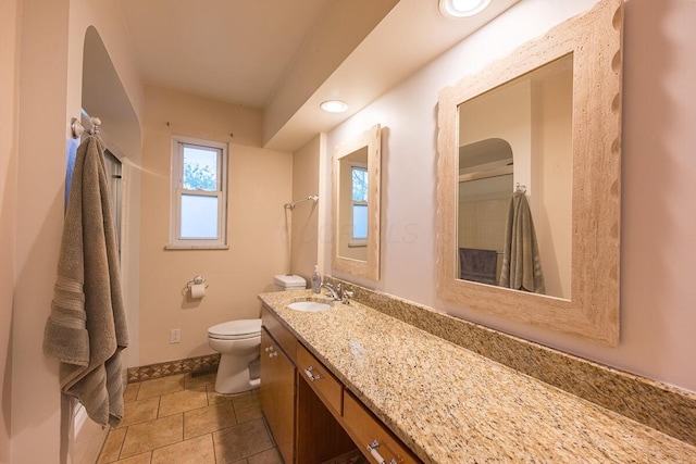 bathroom with tile patterned flooring, vanity, toilet, and curtained shower