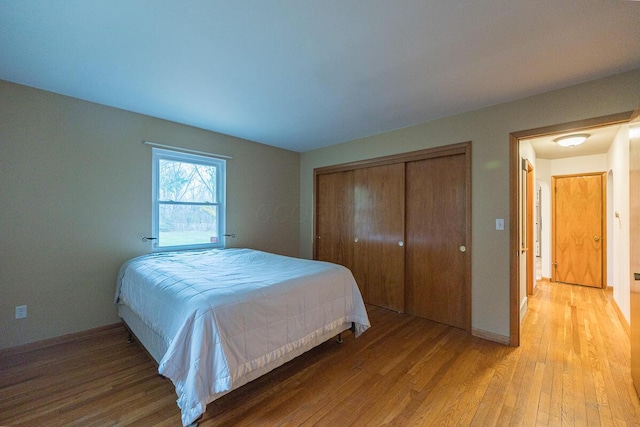 bedroom featuring light wood-type flooring and a closet