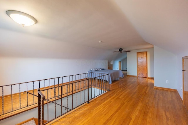 interior space featuring ceiling fan, lofted ceiling, and hardwood / wood-style flooring