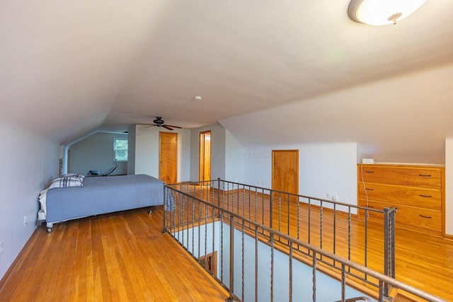 bedroom with vaulted ceiling and hardwood / wood-style flooring