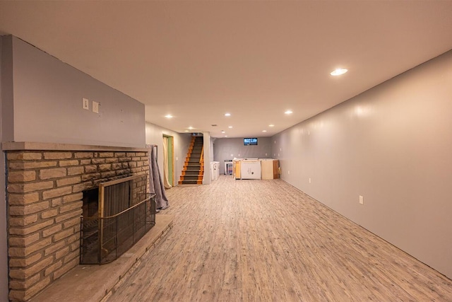 unfurnished living room featuring a fireplace and light hardwood / wood-style floors