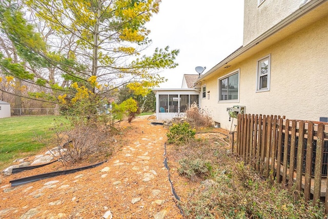 view of yard featuring a sunroom