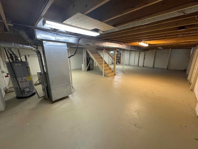 basement featuring gas water heater and heating unit