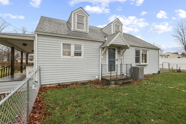 cape cod-style house featuring a front yard and central AC