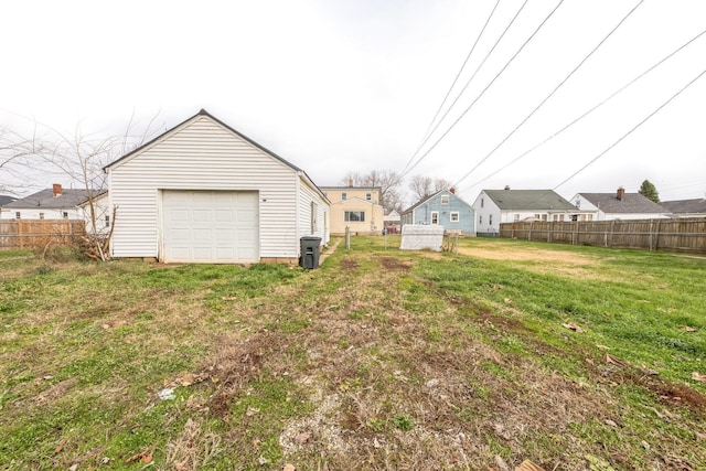 view of yard featuring an outbuilding and a garage