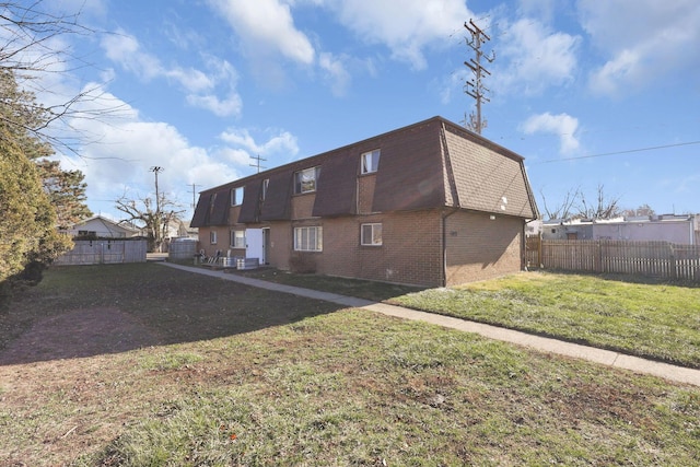 back of house with a lawn