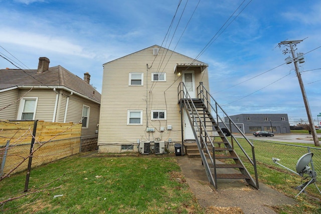 rear view of house featuring a yard