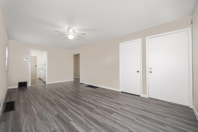 interior space with connected bathroom, dark hardwood / wood-style floors, and ceiling fan