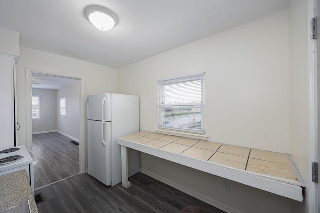 kitchen featuring tile countertops, dark hardwood / wood-style flooring, and white appliances