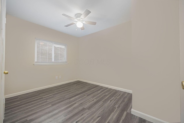 spare room with dark hardwood / wood-style flooring and ceiling fan