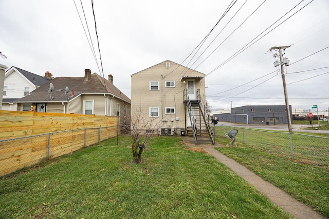 rear view of property featuring a yard