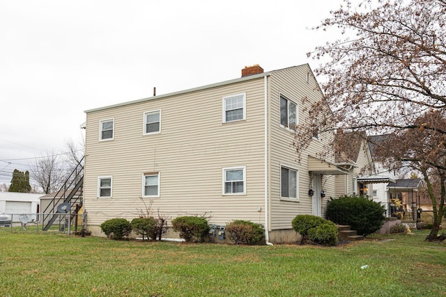 view of side of home featuring a lawn