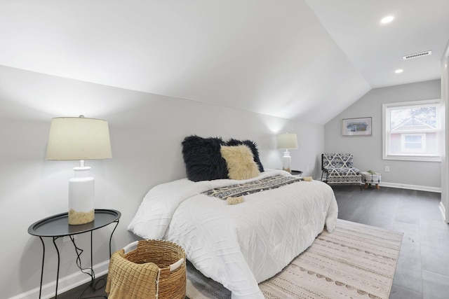 bedroom featuring hardwood / wood-style flooring and lofted ceiling