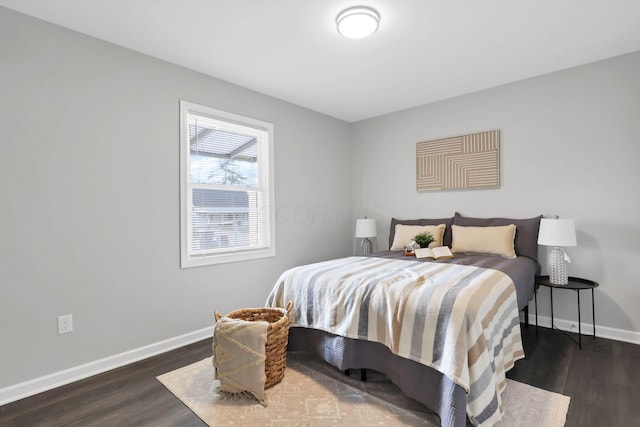 bedroom with dark hardwood / wood-style flooring