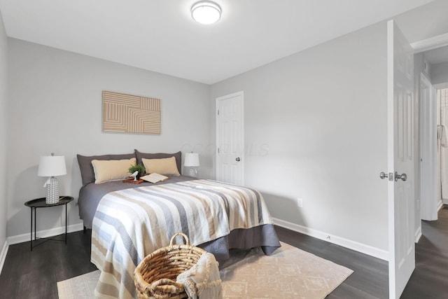 bedroom with dark wood-type flooring