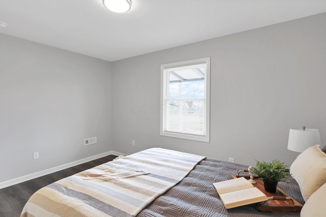 bedroom with dark hardwood / wood-style floors