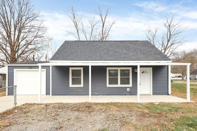 view of front of property with a porch and a garage