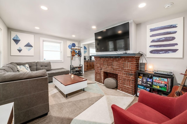 living room featuring a brick fireplace