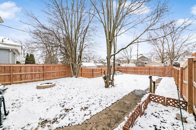 snowy yard featuring an outdoor fire pit