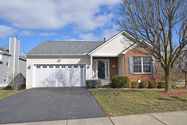 view of front of property featuring a garage and a front yard