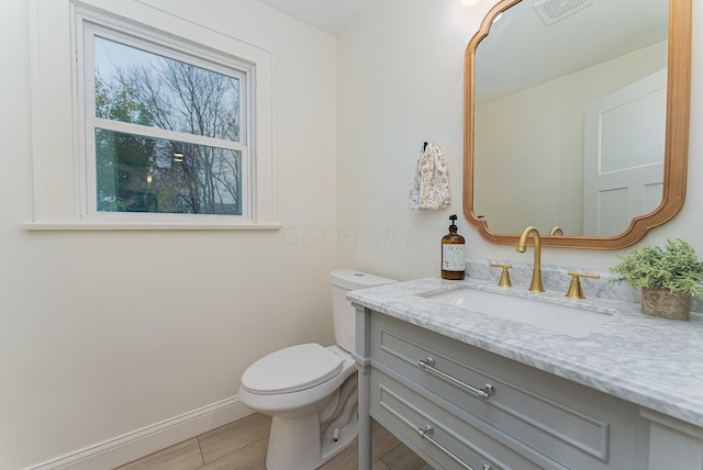 bathroom featuring vanity and toilet