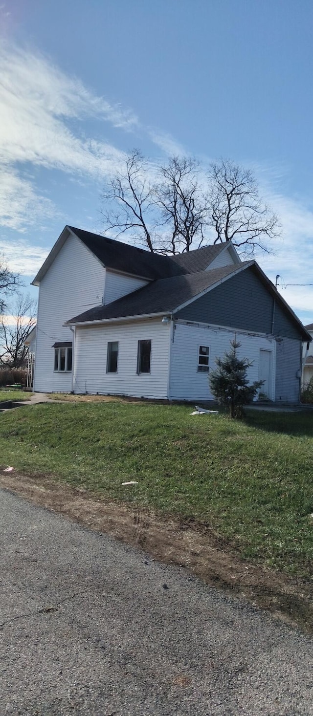 view of side of home featuring a yard