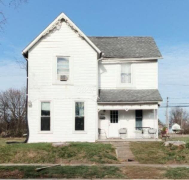 back of property with covered porch