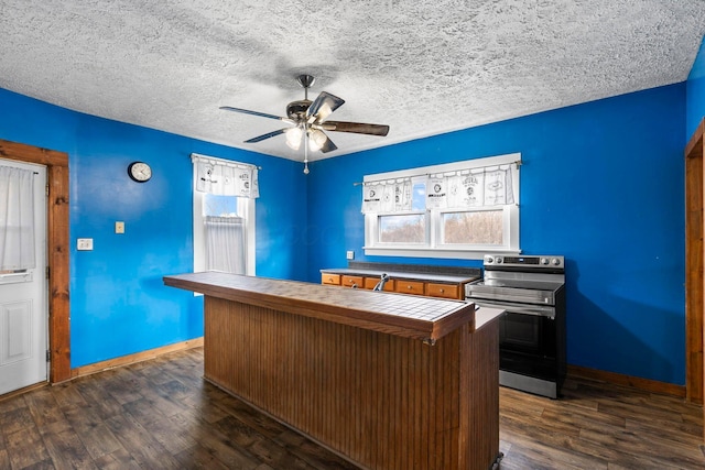 unfurnished office featuring ceiling fan, dark hardwood / wood-style flooring, and a textured ceiling