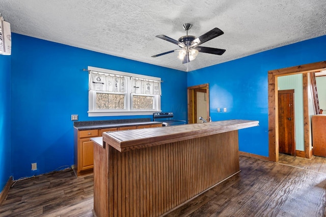 interior space with a textured ceiling and dark hardwood / wood-style flooring