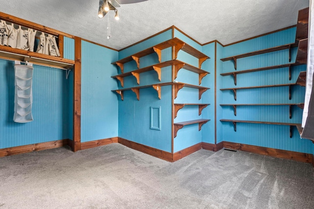 interior space with a textured ceiling and crown molding