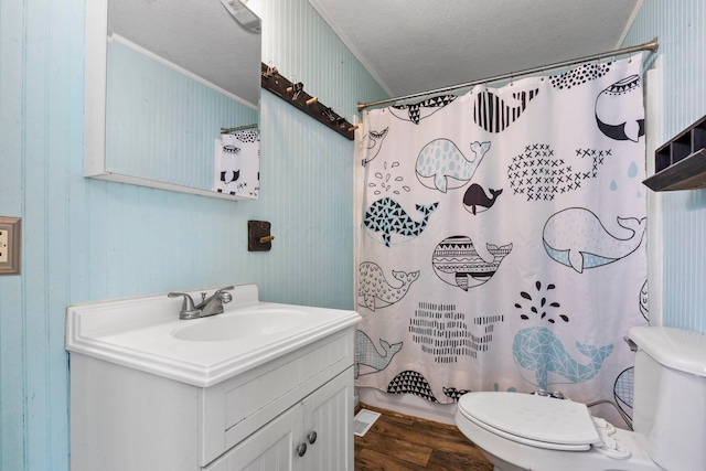 bathroom featuring vanity, a shower with curtain, ornamental molding, a textured ceiling, and wood-type flooring