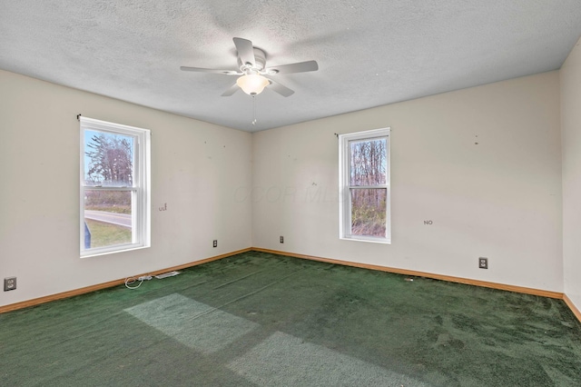 carpeted spare room with ceiling fan and a textured ceiling