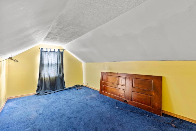 bonus room with carpet flooring, a textured ceiling, and lofted ceiling