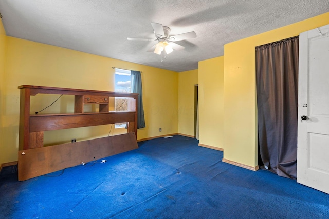 interior space with ceiling fan, a textured ceiling, and dark colored carpet