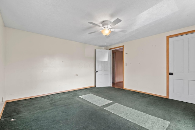 empty room featuring ceiling fan, carpet floors, and a textured ceiling