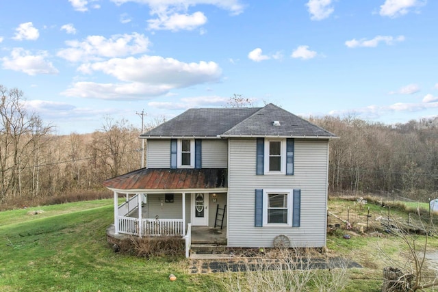 view of front of property with covered porch and a front yard