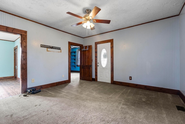 entrance foyer featuring a textured ceiling, carpet floors, and ceiling fan