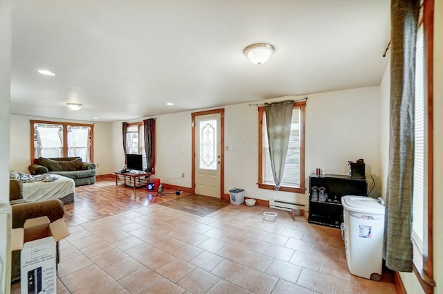 tiled foyer featuring baseboard heating