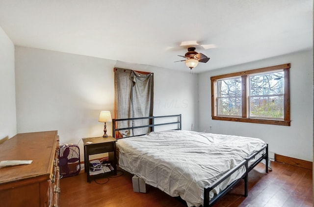 bedroom with ceiling fan, dark wood-type flooring, and pool table