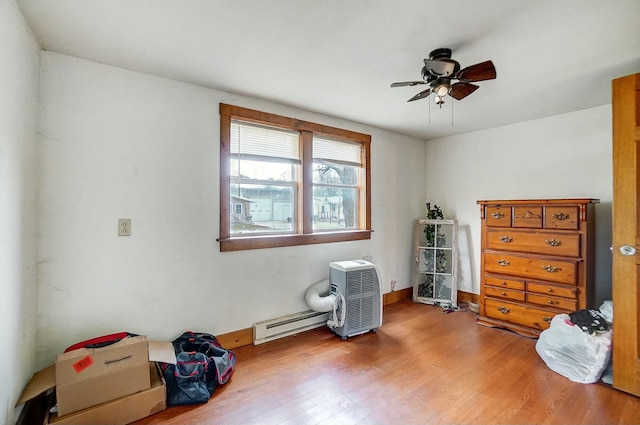 misc room featuring hardwood / wood-style flooring, baseboard heating, and ceiling fan