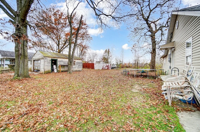 view of yard with an outdoor structure and a trampoline