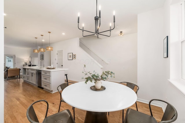 dining room with sink and light hardwood / wood-style flooring