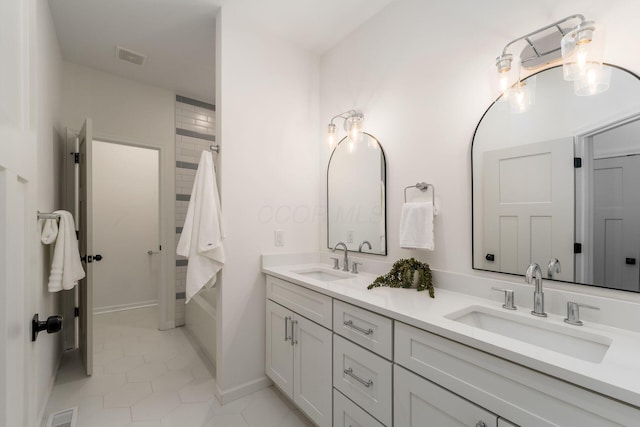 bathroom with tile patterned floors and vanity