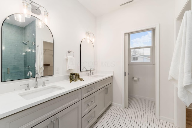 bathroom with vanity and a shower with shower door