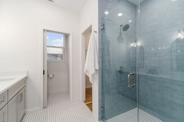 bathroom with vanity and a shower with door